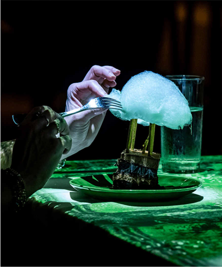 A person with fork trying a dessert